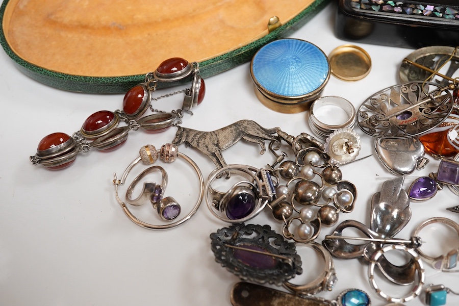 A quantity of assorted silver and costume jewellery including a Georg Jensen style brooch, a graduated coral bead necklace, 56cm, gross weight 35 grams, pair of coral drop earrings, a George V silver combination latter o